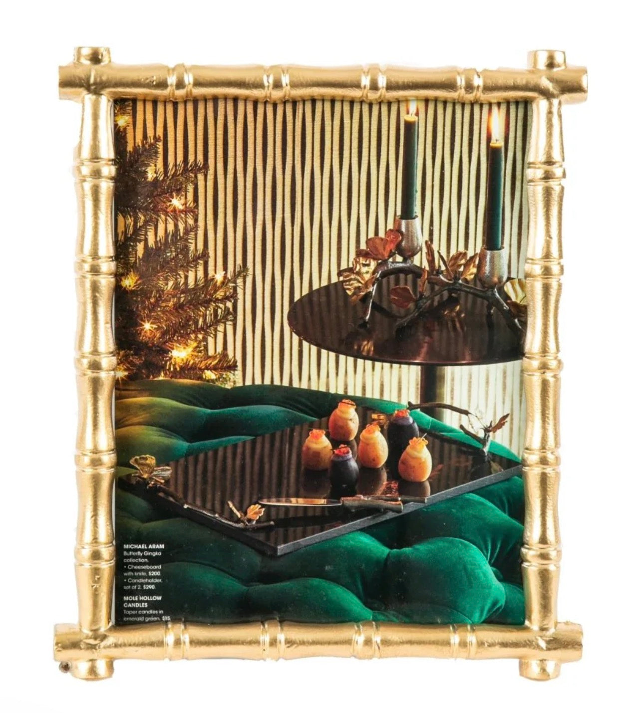 Decorative display with gold frame, green velvet base, and various items including a Christmas tree and figurines.
