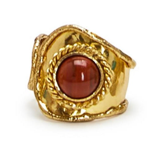 Gold ring with a red stone on a white background