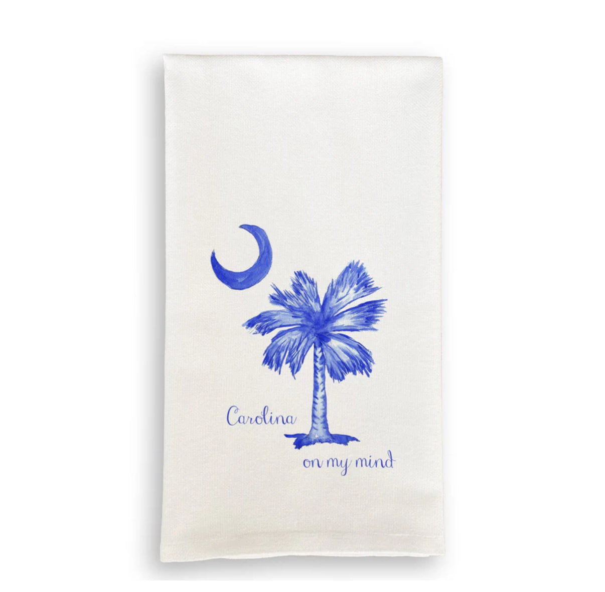 White towel with blue palm tree and moon design on a white background