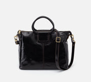 Black leather handbag with a shoulder strap on a white background