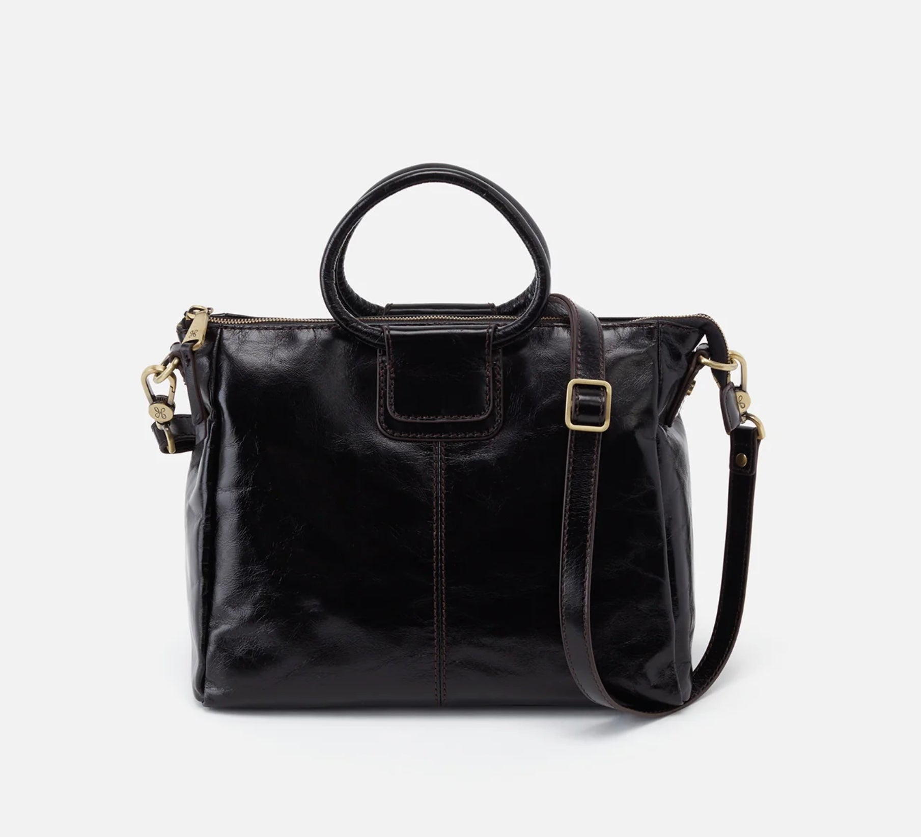 Black leather handbag with a shoulder strap on a white background