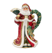 Decorative figurine of a Santa Claus holding a wreath on a white background