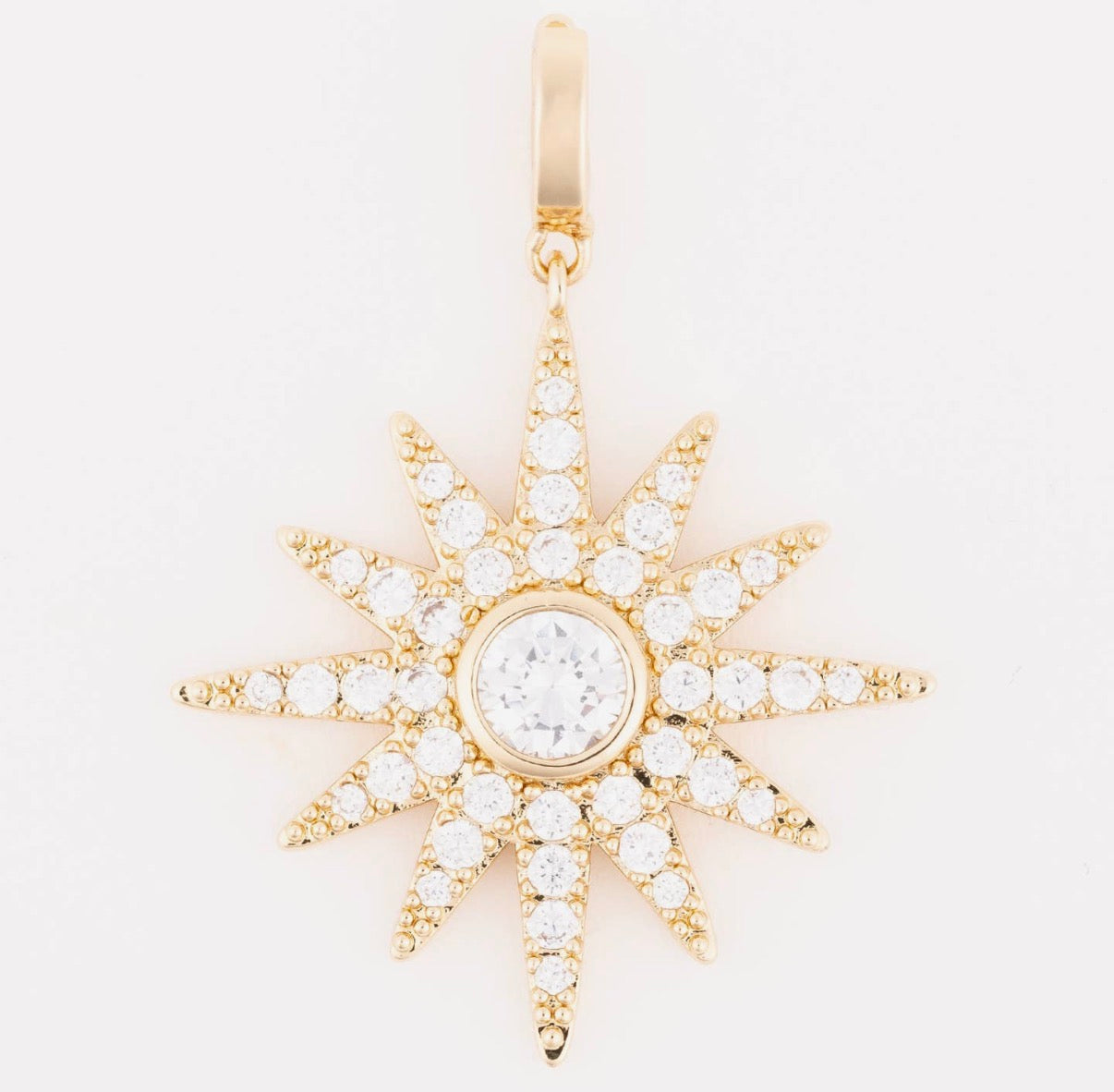 Gold star-shaped pendant with clear stones on a white background