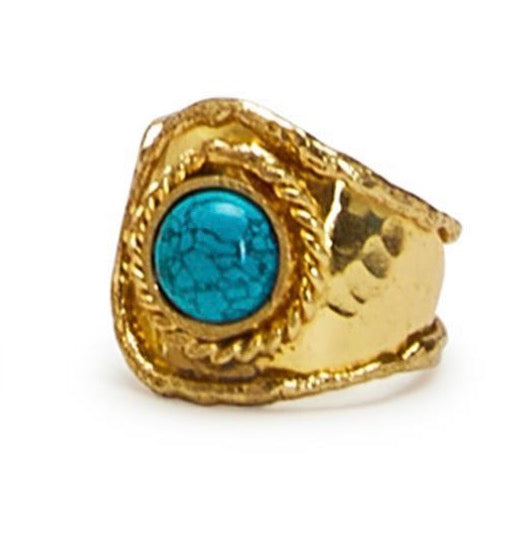 Gold ring with a blue stone on a white background