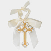 Decorative cross with white ribbon on a light gray background