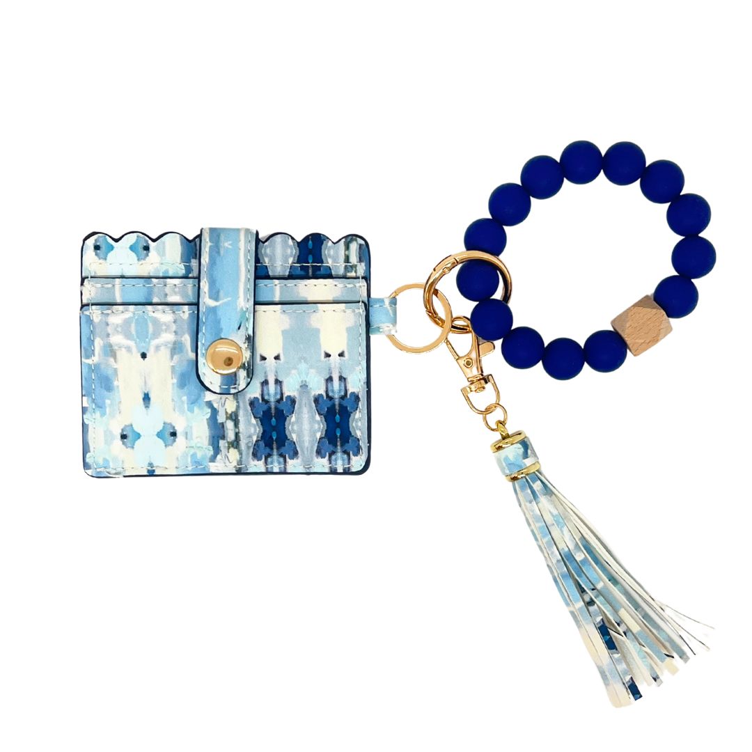 Blue and white patterned cardholder with a matching keychain on a white background