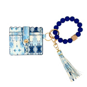 Blue and white patterned cardholder with a matching keychain on a white background