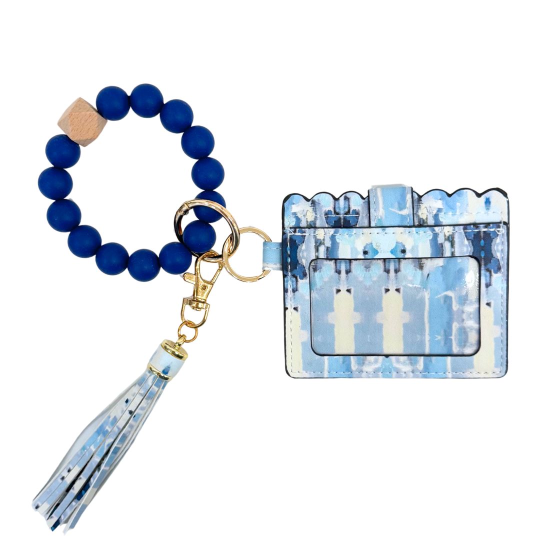 Blue beaded keychain with tassel and matching cardholder on a white background