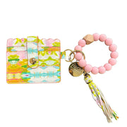 Colorful keychain with pink beaded bracelet and tassel on a white background