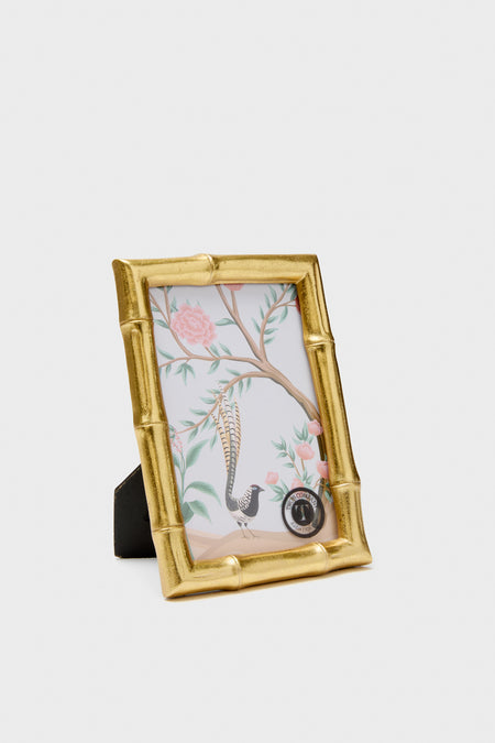 Gold photo frame with a decorative design on a white background