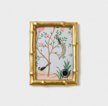 Decorative framed artwork with birds and plants on a light gray background