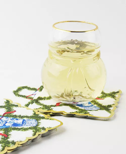 Glass of white wine on decorative coasters with a white background