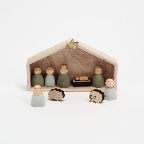 Wooden nativity scene with figures and a star on a white background