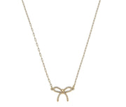 Gold necklace with a bow pendant on a white background