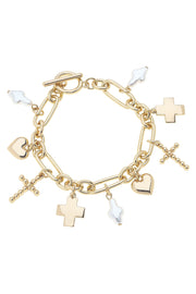 Gold charm bracelet with various charms on a white background
