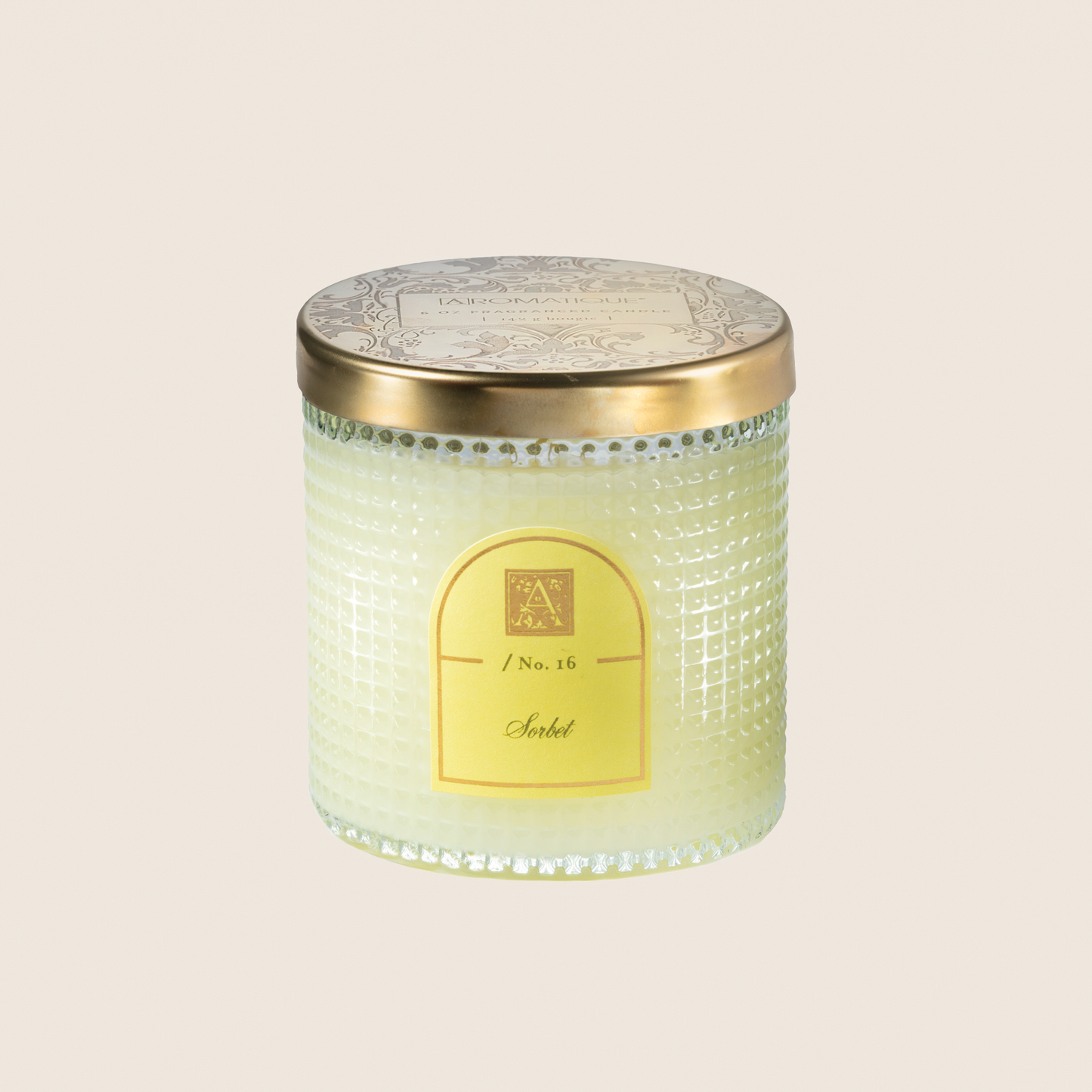 Candle with decorative lid on a light beige background