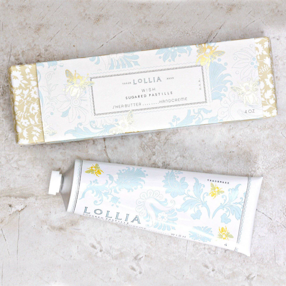 Two Lollia product packages on a light stone surface