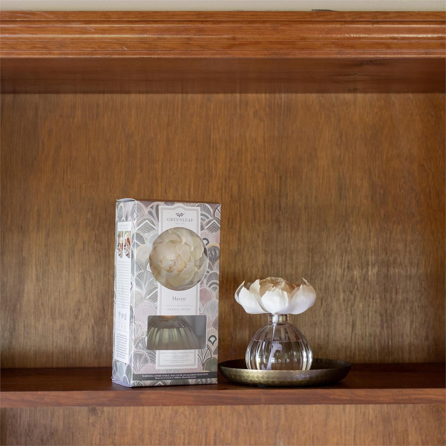 Decorative item packaging with a glass vase on a wooden shelf
