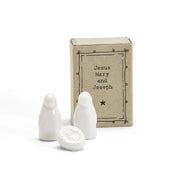 White ceramic nativity figures with a decorative box labeled 'Jesus Mary and Joseph' on a white background.