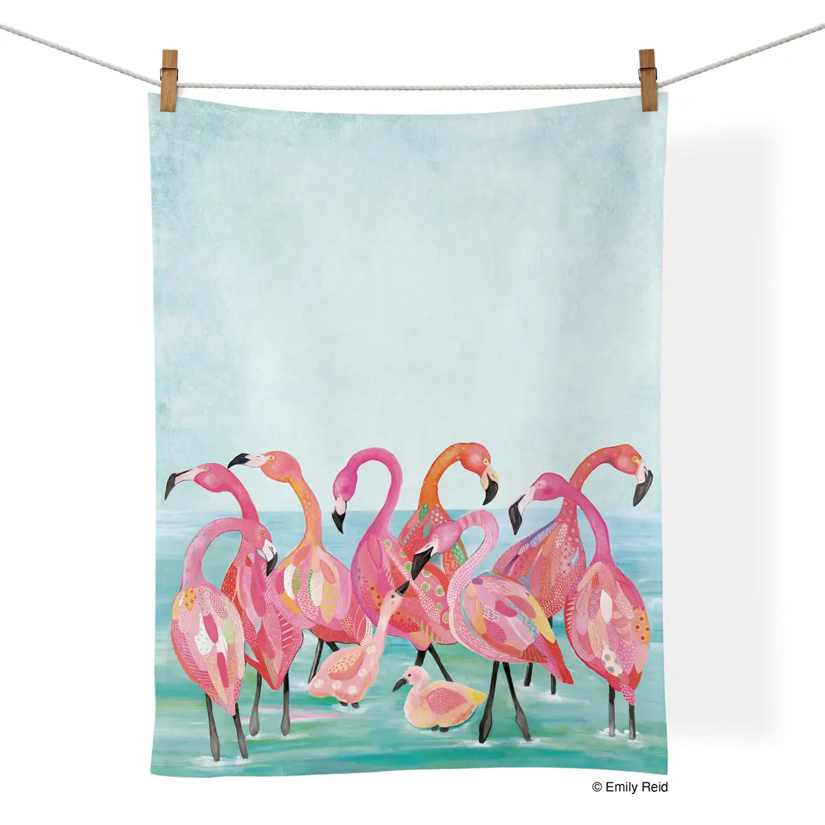 Tea Towel - Flamingo Beach- picture is of a tea towel with flamingos on a beach in the water and the tea towel is hanging on a clothes line