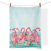 Tea Towel - Flamingo Beach- picture is of a tea towel with flamingos on a beach in the water and the tea towel is hanging on a clothes line
