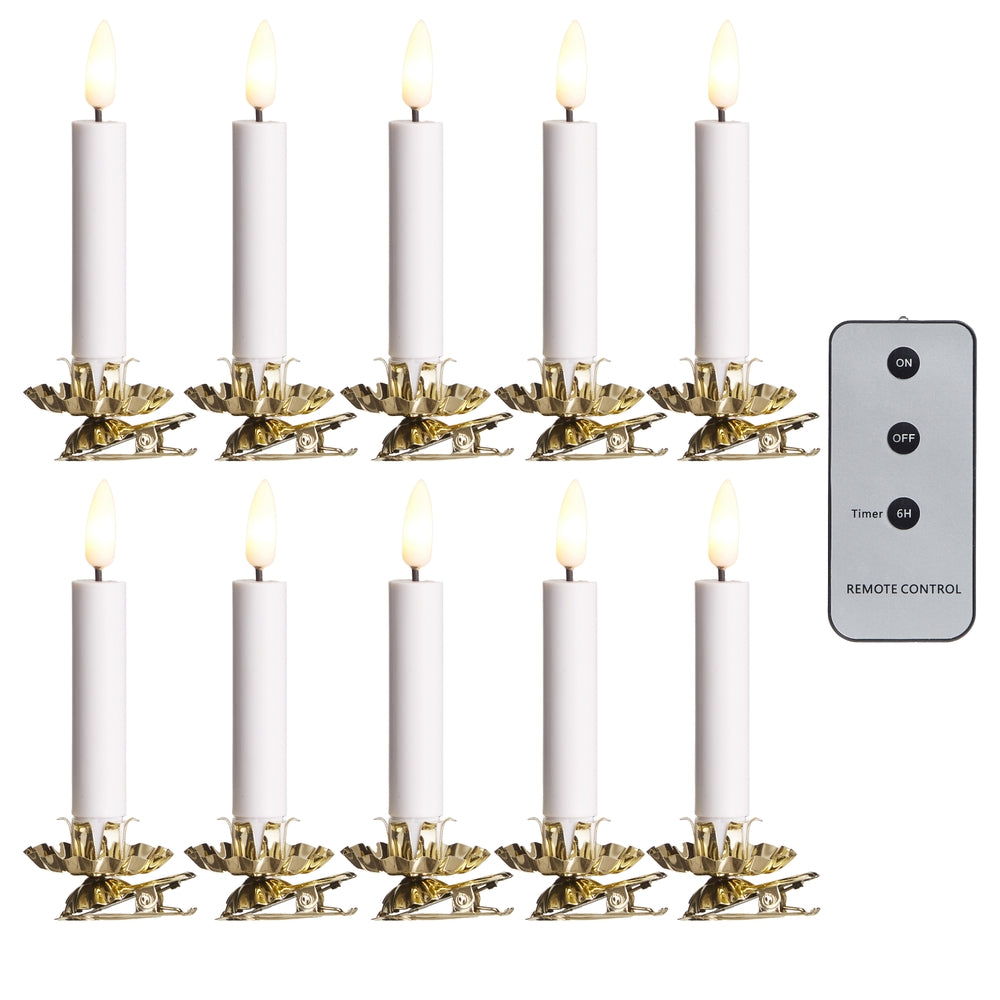 Set of white candles with gold holders and a remote control on a white background