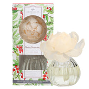 Decorative diffuser with floral design and packaging featuring greenery and berries.