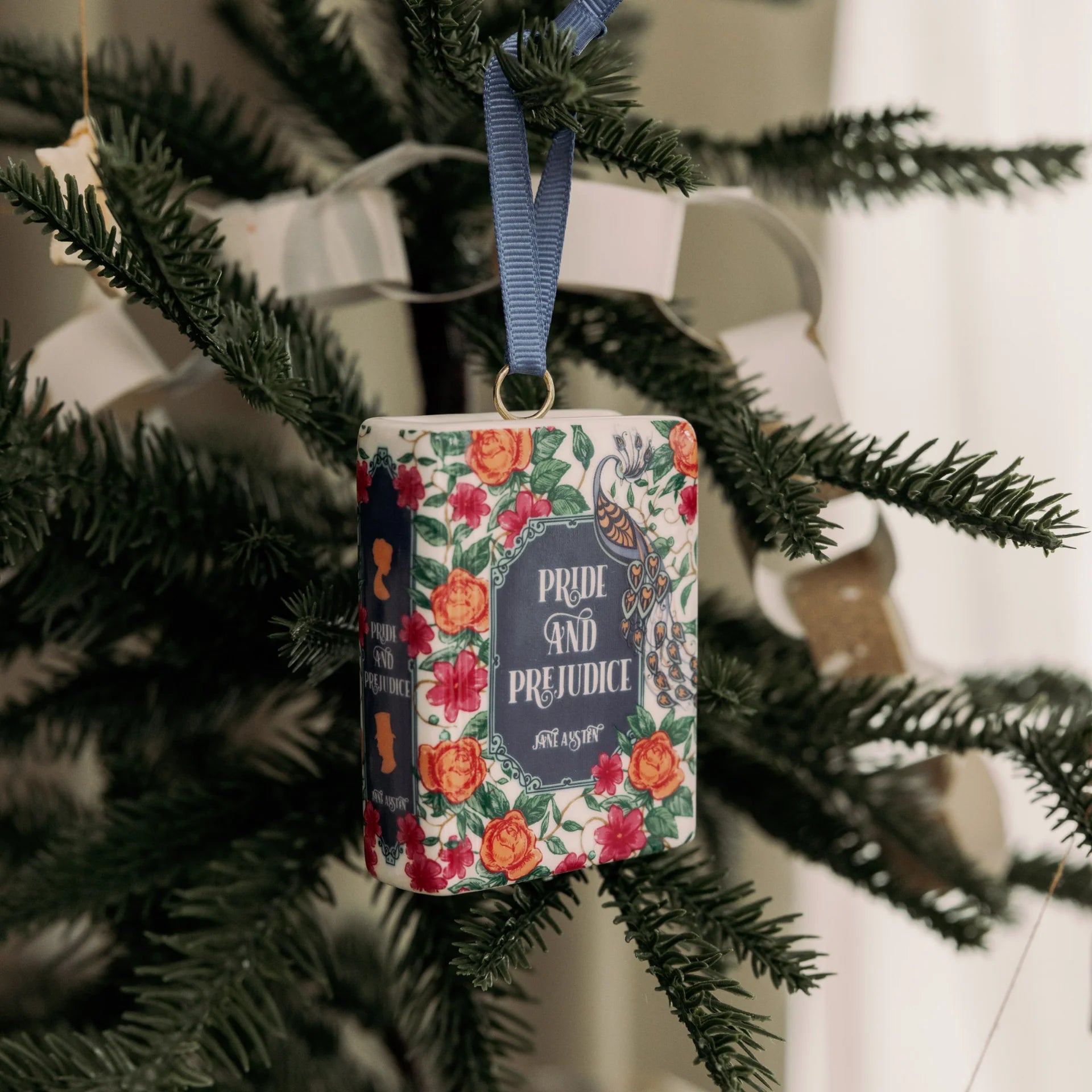 Seasonal - Ornament - Book shape - Pride and Prejudice hanging on a Christmas tree branch. 