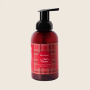 The smell of Christmas candle with red label - beige background 