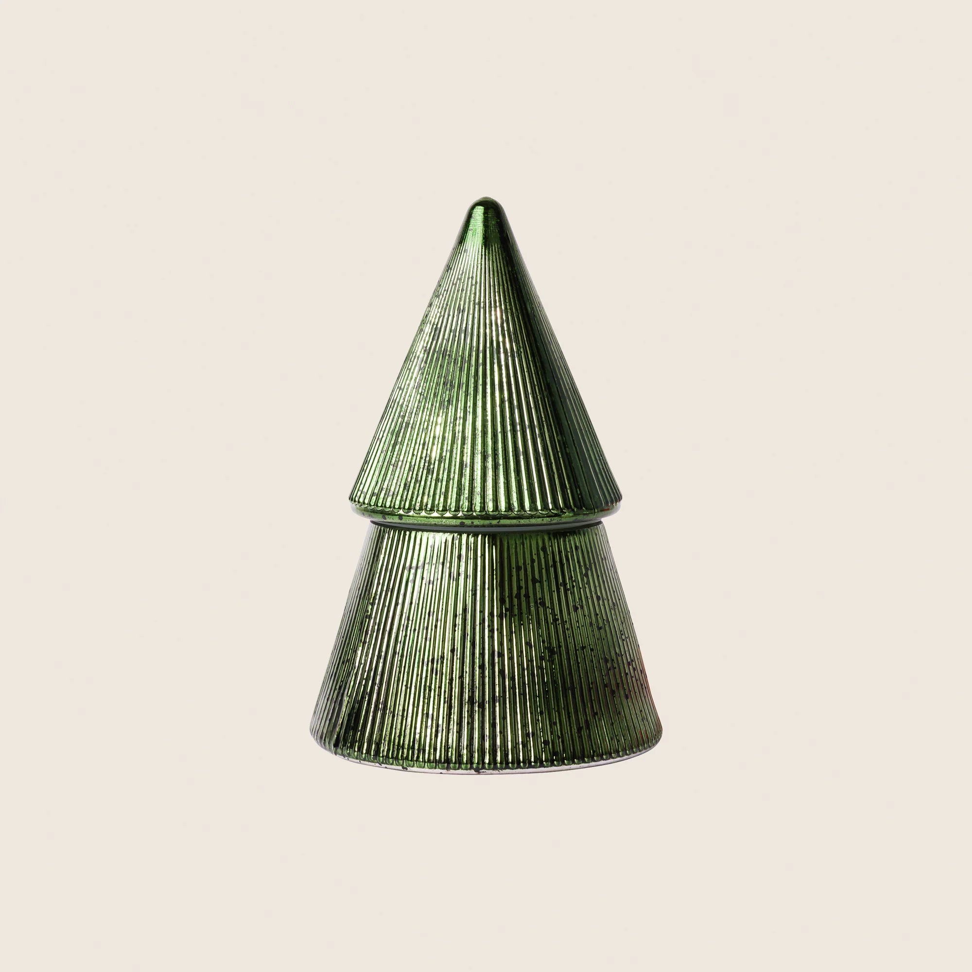 Metallic tree shaped candle on beige background 