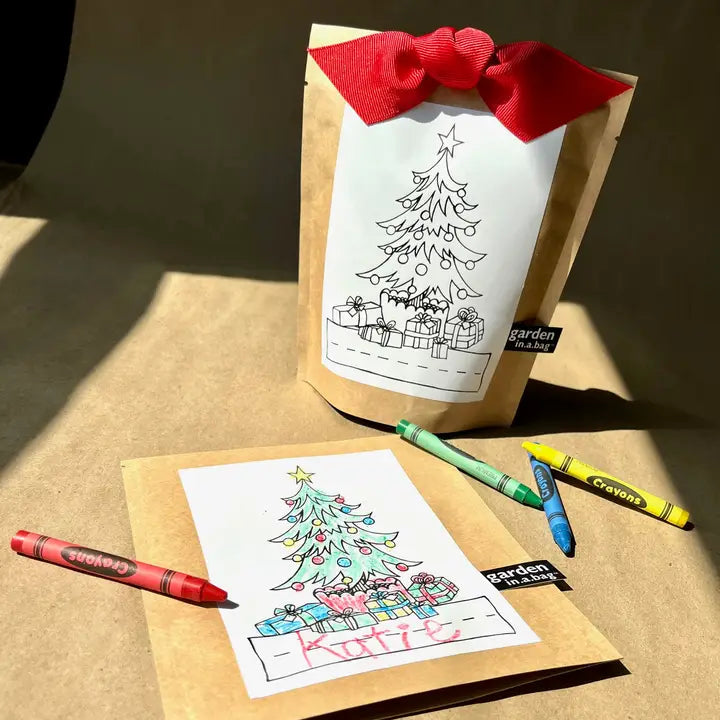 Kraft paper bag with a Christmas-themed coloring book and crayons on a brown surface.