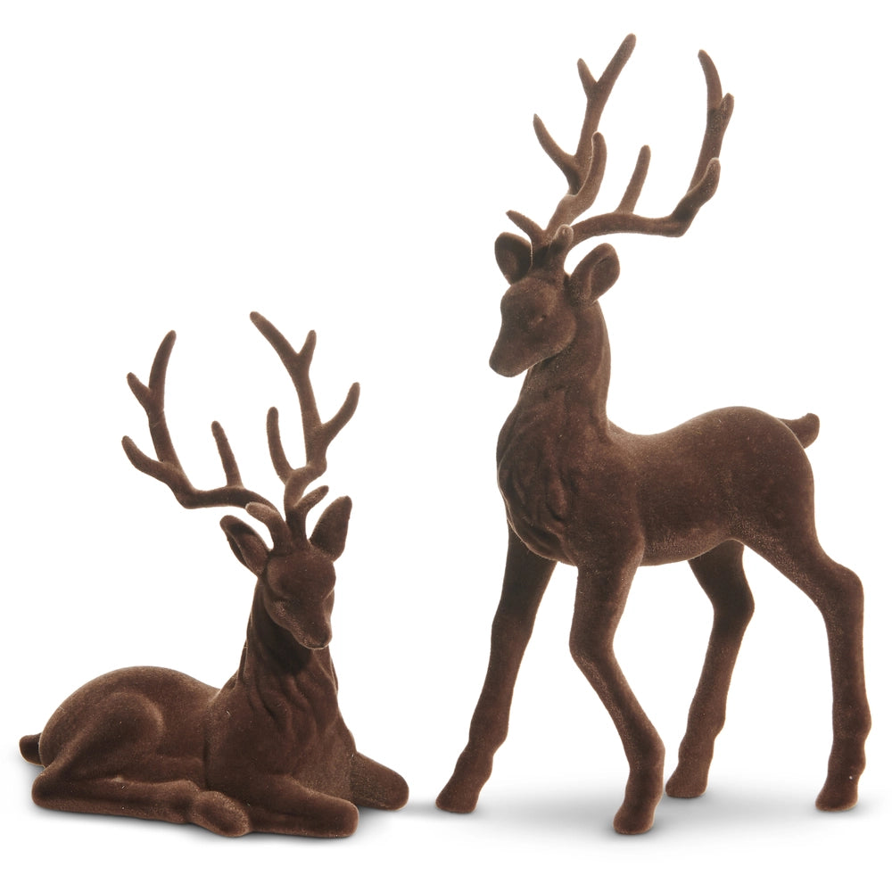 Two brown deer figurines, one standing and one lying down, on a white background.