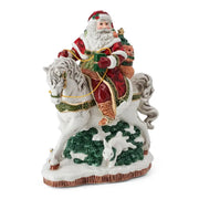 Decorative figurine of Santa Claus riding a horse with a white rabbit on a white background
