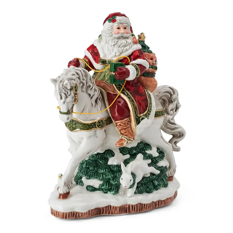 Decorative figurine of Santa Claus riding a horse with a white rabbit on a white background