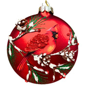 Red glass ornament with a cardinal design on a white background