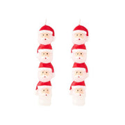 Set of Santa Claus-shaped candles on a white background