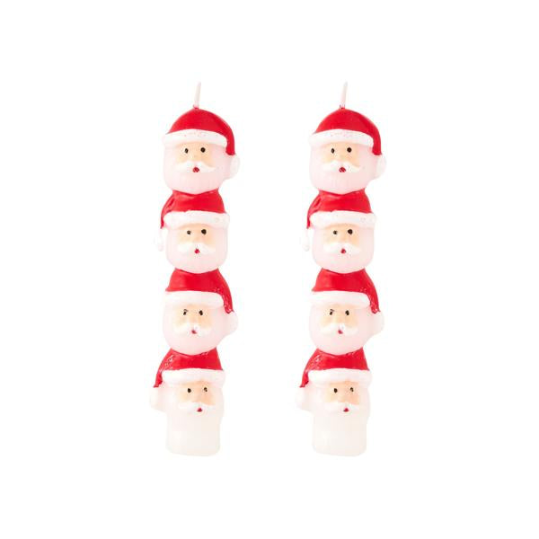 Set of Santa Claus-shaped candles on a white background