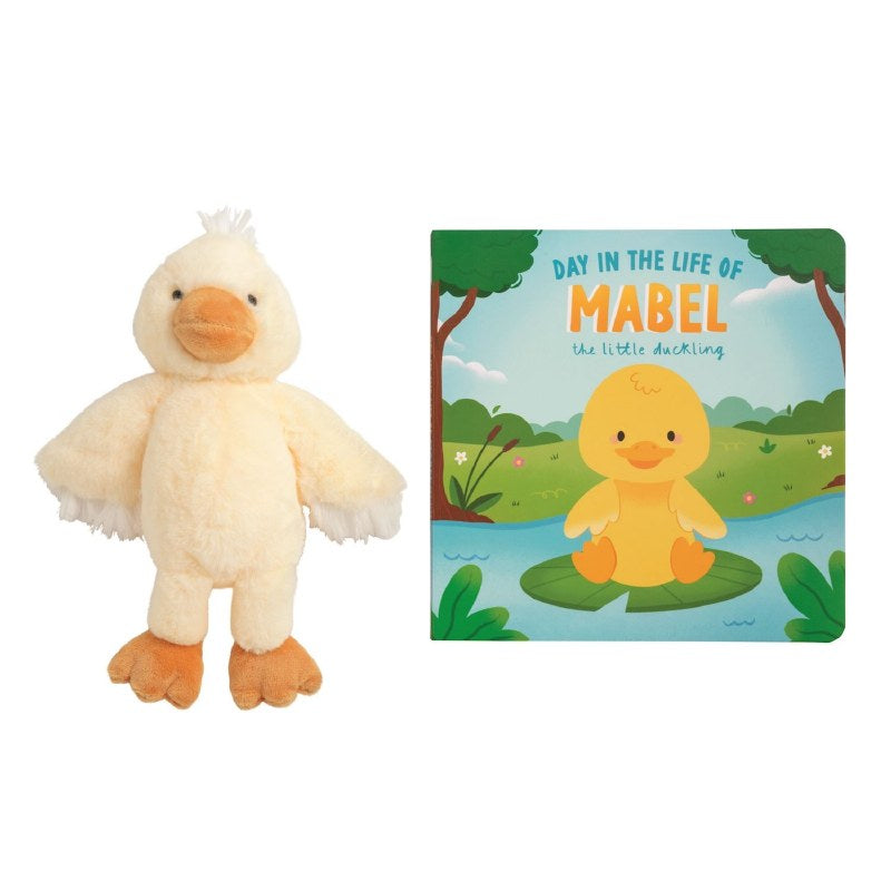 Plush duck toy and children's book titled 'Day in the Life of Mabel the Little Duckling' on a white background