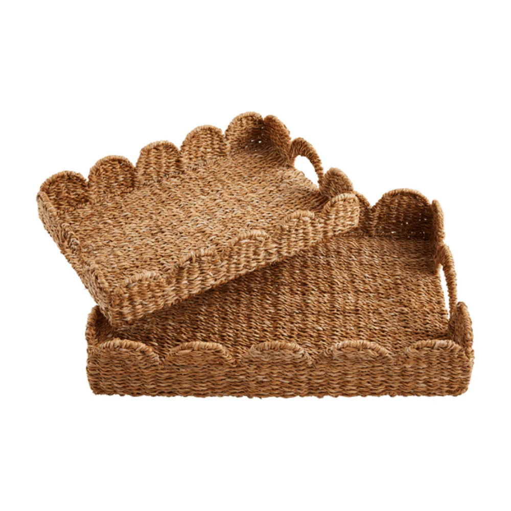 Brown woven basket with scalloped edges on a white background