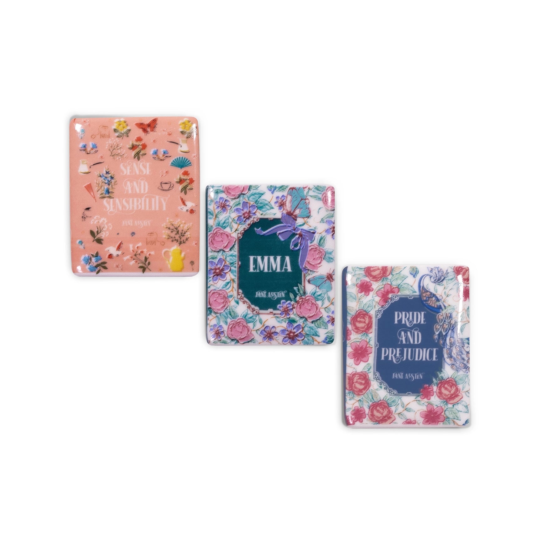 Three book covers magnets with floral designs and text on a white background