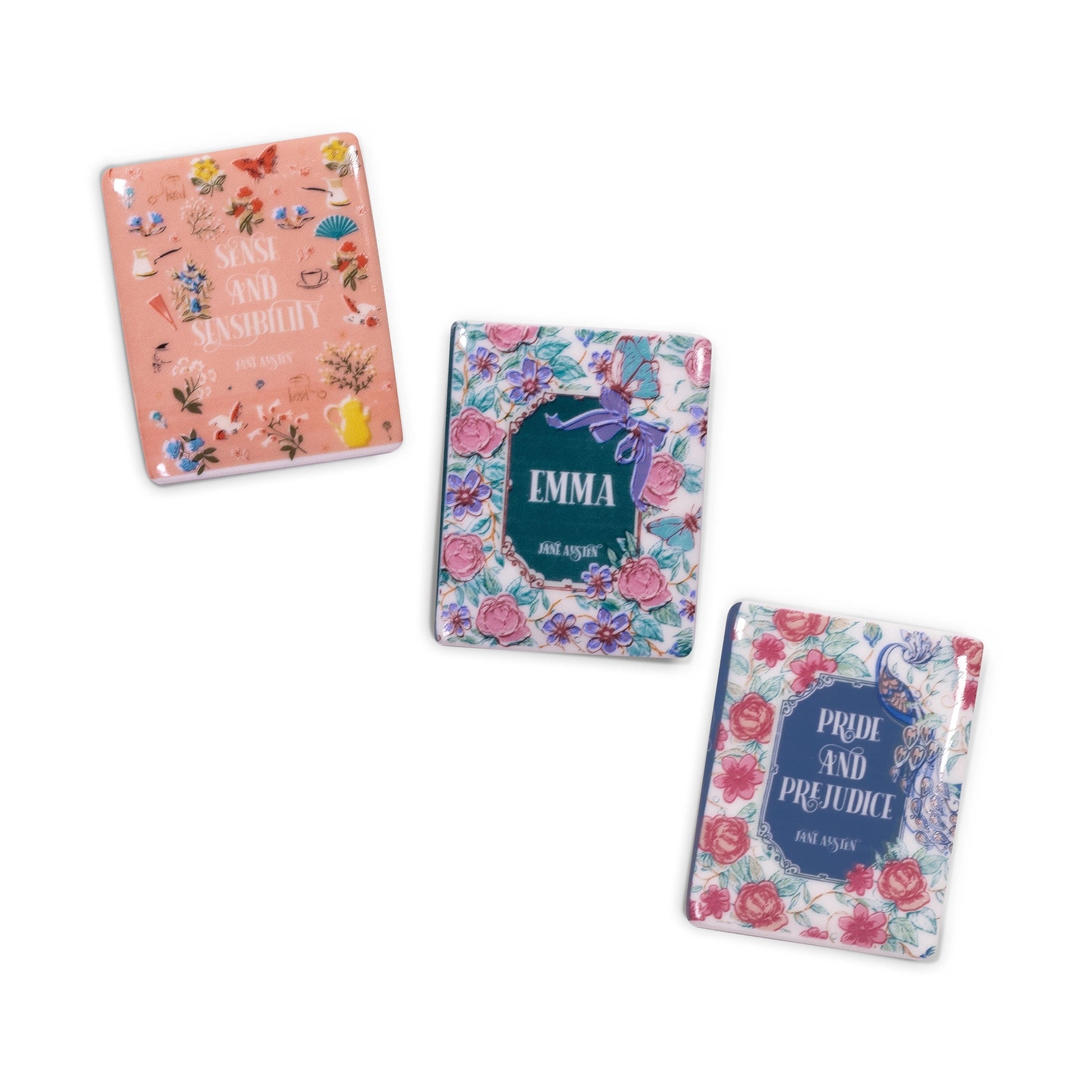 Three book magnets with floral designs and book titles on a white background
