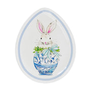 Decorative egg-shaped plate with a bunny and floral design on a white background