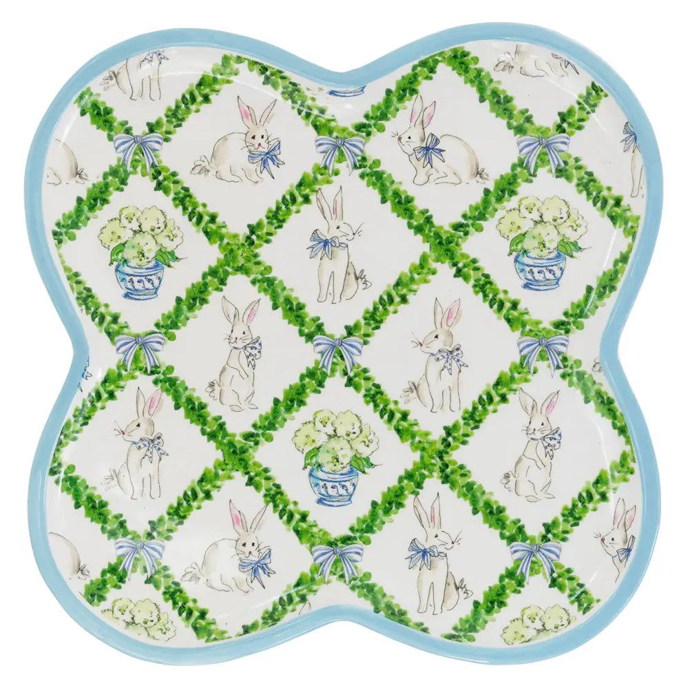 Decorative platter with bunny and flower pattern on a white background