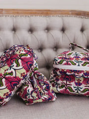 Two patterned bags on a textured surface with a blurred background
