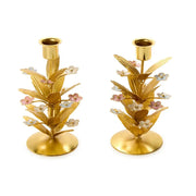 Pair of gold candle holders with pastel flowers on gold leaves floral designs on a white background