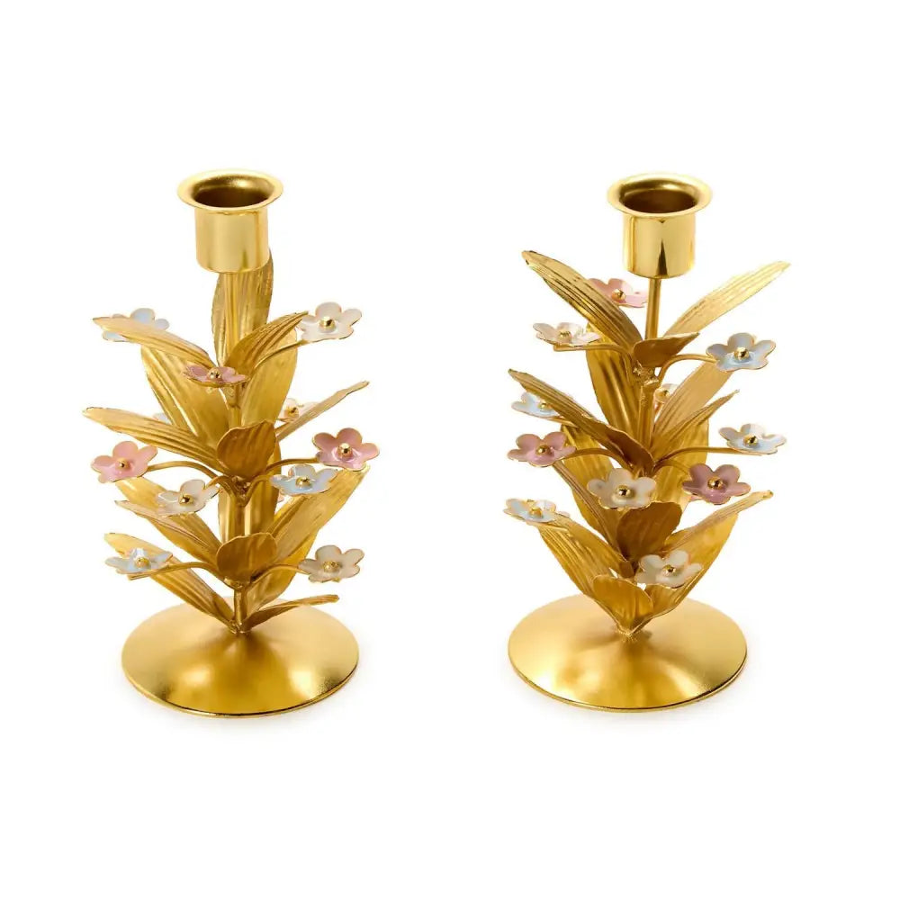 Pair of gold candle holders with pastel flowers on gold leaves floral designs on a white background