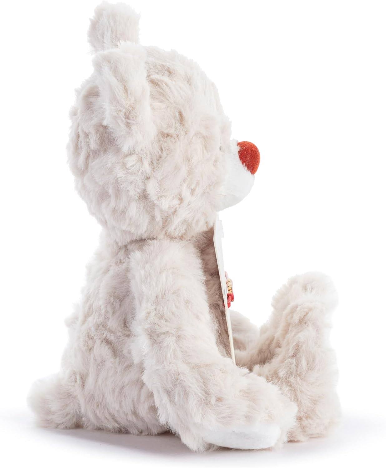 White plush dog toy with a red nose on a white background