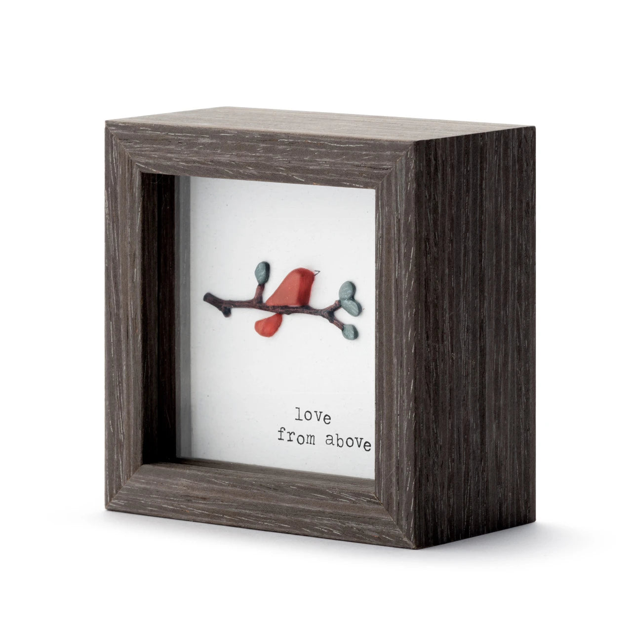 Decorative box with a branch and red leaf design and text 'love from above' on a white background.