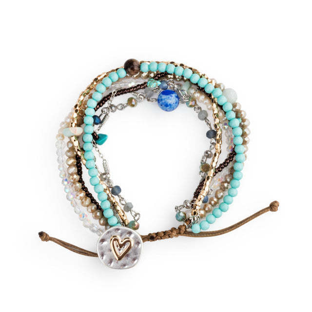 Multistrand beaded bracelet with heart charm on a white background