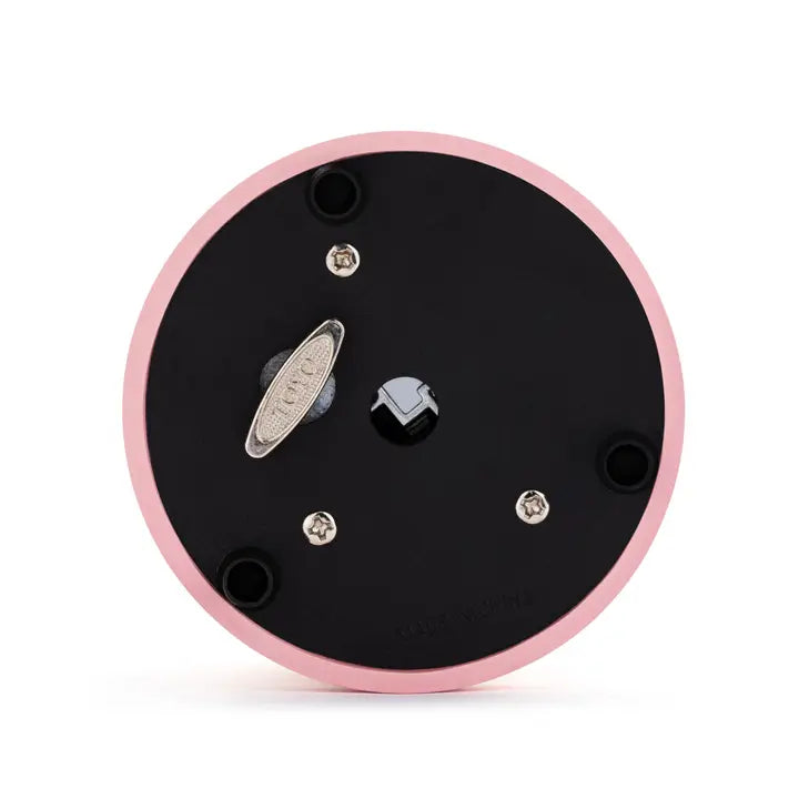 Black circular component with pink rim on a white background